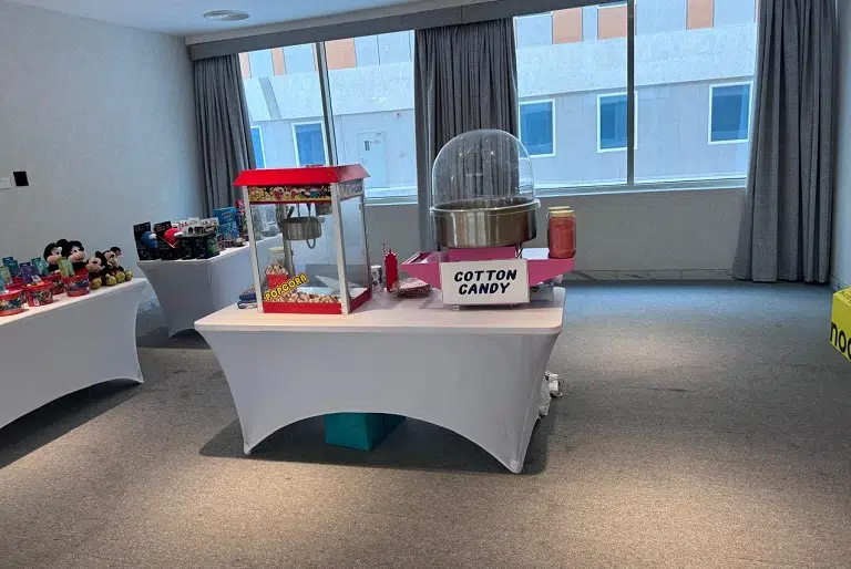 Popcorn and Cotton Candy Machine Rental setup on a table for kids indoor event